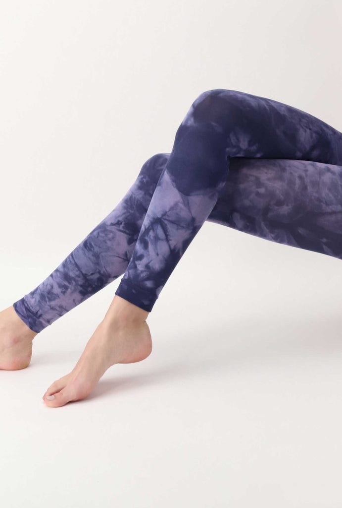 Outstretched lady's legs in marine blue tie-dye footless tights.  