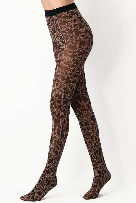 Side view of lady's legs walking in leopard print tights.