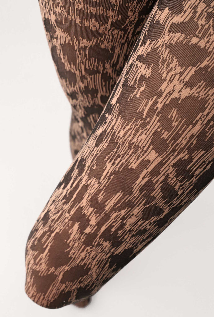 Close up of lady's thighs, wearing leopard print tights.