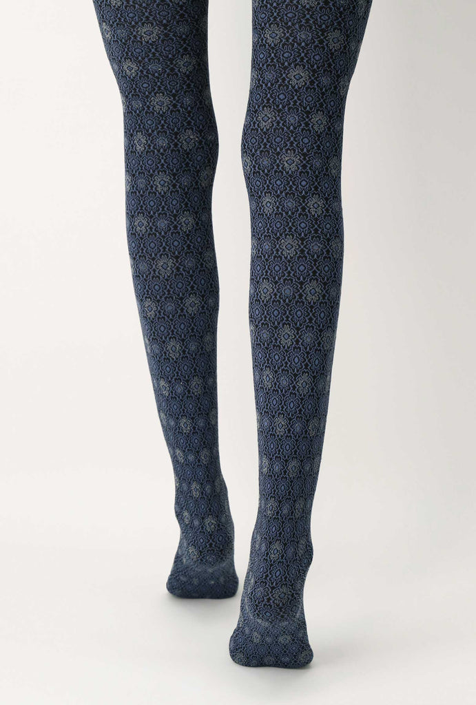 Back view of lady's legs walking in blue and black floral tights.