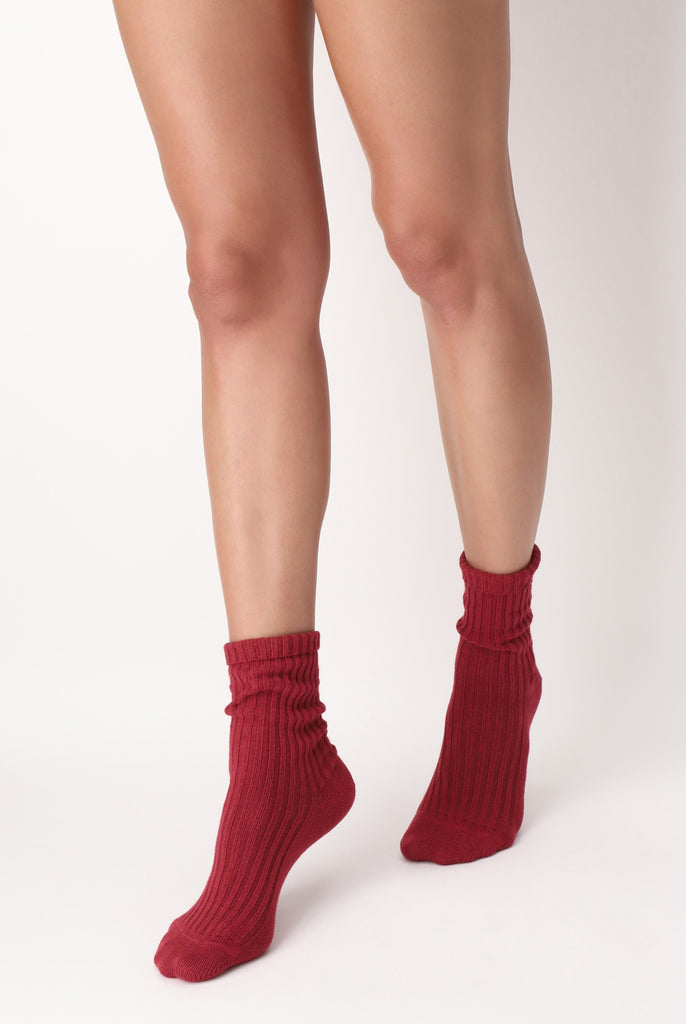 Lady's legs in walking stance, wearing red rib socks.