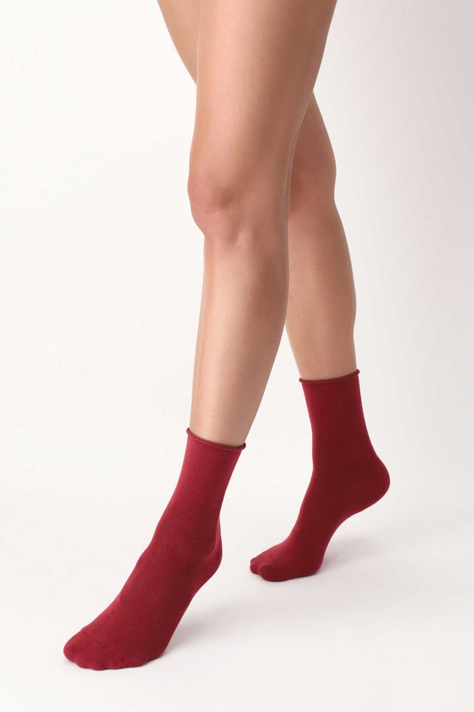 Lady's feet in red socks in walking motion.