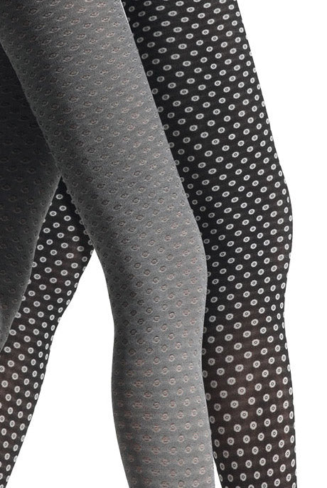 Close up of lady's legs in black and white dot tights.