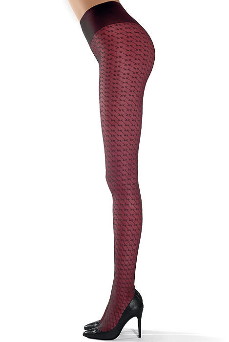 Sideway view of a lady's legs standing wearing bordeaux geometric pattern sheer tights in  black high heeled shoes.