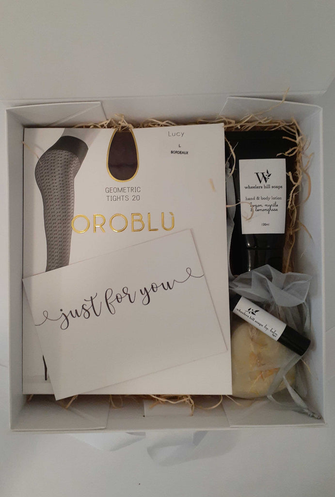 Gift box with hosiery and beauty products.
