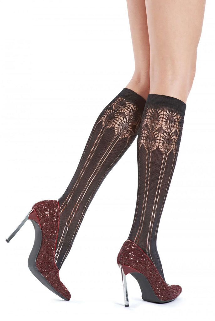 Close up of lady's lower legs wearing Oroblu brown melange Penny knee high socks in burgundy shoes.