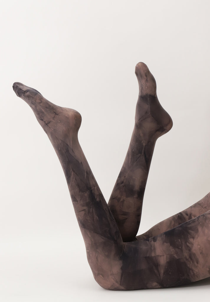 lady's legs, swinging in the air, wearing brown tie dye tights.