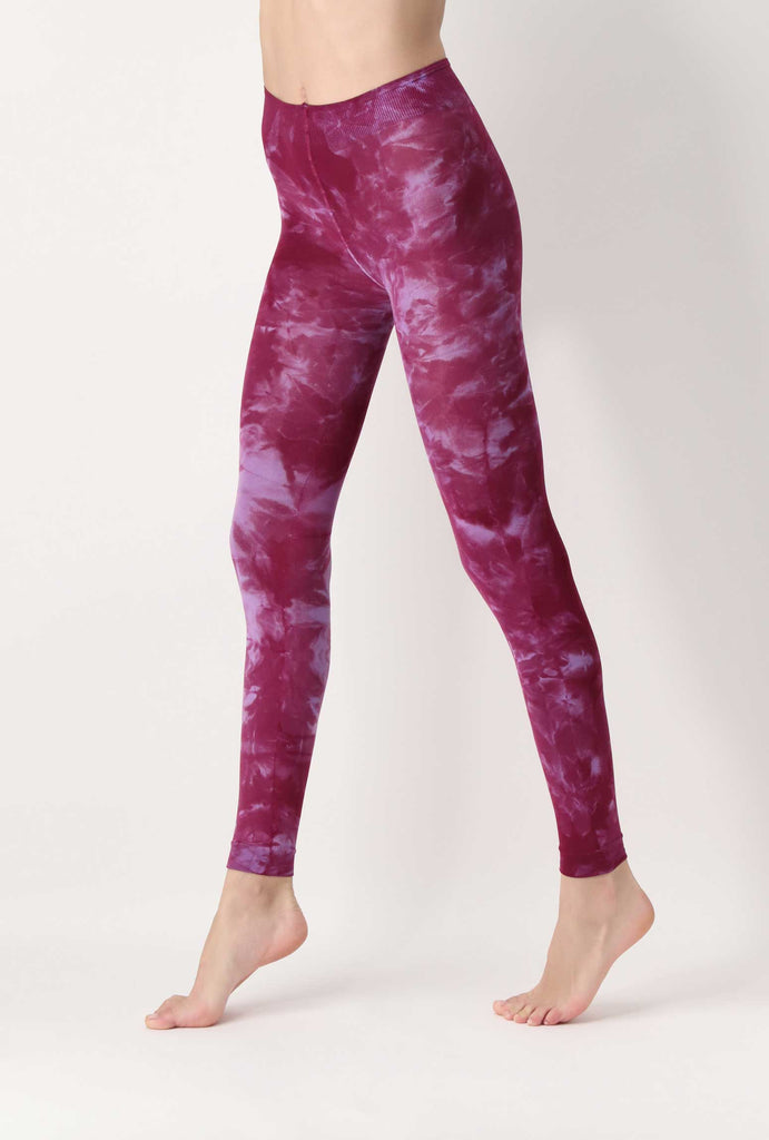 Side view of lady's legs in lilac pink tie-dye leggings.