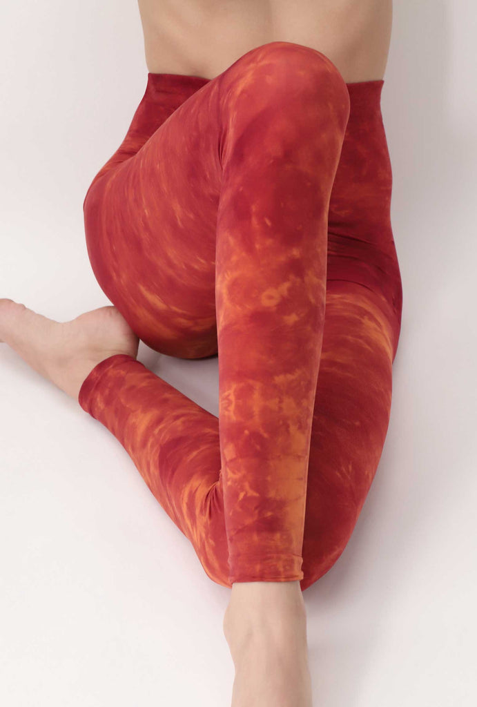 Front view of lady's legs wearing orange and tie-dye leggings.