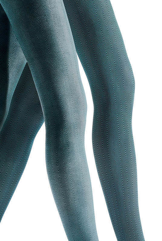 Close up of lady's legs in green and black pattern tights.