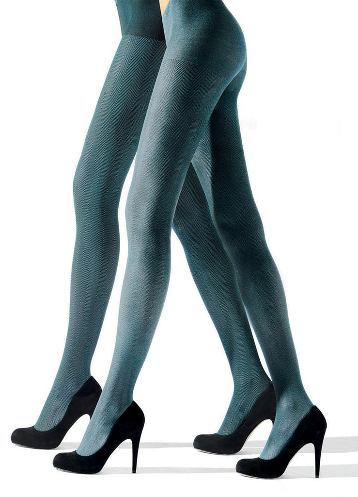 Side view of lady's legs in green tights and black heels.